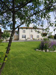 a house with a green lawn in front of it at Gîte menthe à l'eau in Ciadoux