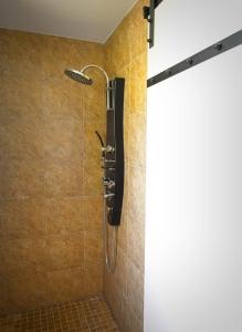 a shower with a shower head in a bathroom at Renovated 6 Bedroom Chalet Hot Tub Near Village in Blue Mountains +66 photos
