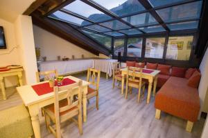 a living room with tables and chairs and a couch at "VILLA DENY" Boutique HOTEL - with FREE PARKING in Mostar +79 photos