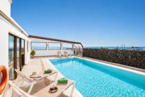a swimming pool with a view of the ocean at Villa Asomada in La Asomada