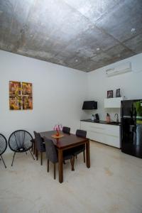 a living room with a table and a kitchen at Sudu Appu Villa Beruwala in Beruwala