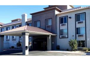 a large building with a parking lot in front of it at Studio 6 Suites Hesperia CA West Main Street I 15 in Hesperia