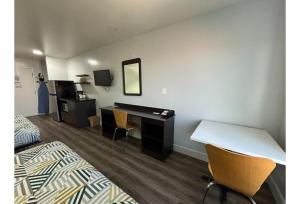 a room with a desk and a bed and a desk at Studio 6 Suites Hesperia CA West Main Street I 15 in Hesperia