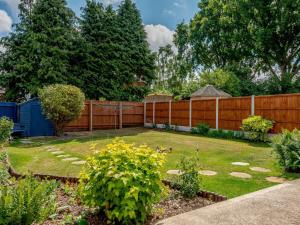 a backyard with a wooden fence and a garden at 2 Bed in Ferndown oc-78541 in Ferndown +9 photos