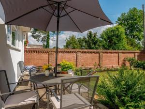 a table and chairs with an umbrella on a patio at 2 Bed in Ferndown oc-78541 in Ferndown