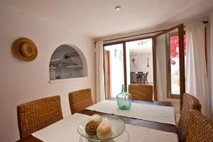 a dining room with a table with a vase on it at Ca nostra in Artá