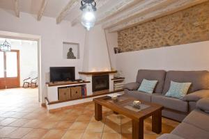a living room with a couch and a fireplace at Ca nostra in Artá