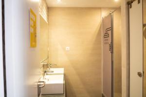 a bathroom with a sink and a mirror at Onefam Ramblas in Barcelona +22 photos
