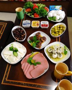 a wooden table with plates of food on it at Cairo Center in Cairo