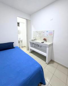 a bedroom with a blue bed and a sink at Hotel Posada Centro Atlacomulco Cuarto Barra in Atlacomulco de Fabela