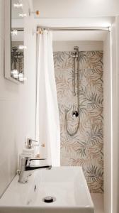 a bathroom with a sink and a shower at Maison La Chicca in Molfetta