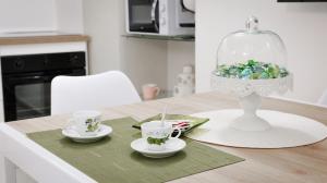 a table with two cups and a glass cloche on it at Maison La Chicca in Molfetta