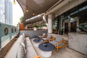 a restaurant with tables and chairs on a building at Media One Hotel Dubai, WorldHotels Crafted in Dubai