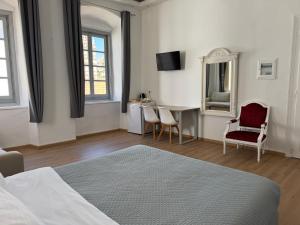 a bedroom with a bed and a table and chairs at Douskos Guesthouse in Hydra