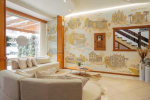 a living room with a couch and a wall with a mural at Hotel Prata Villaggio in Nova Prata +31 photos