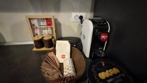 a counter with a coffee maker and a basket of food at Agnesa Apartament in Gramsh