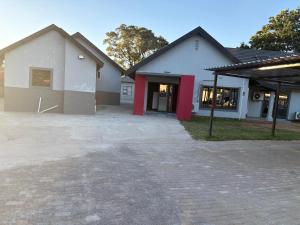 a house with a driveway in front of a building at Unit 5 and 6 Homely Escapes in Phalaborwa