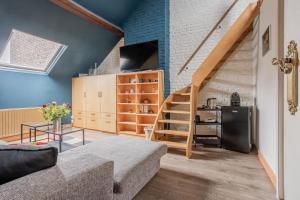 a living room with a staircase and blue walls at Brussels Guest House in Brussels