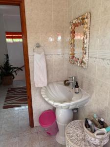 a bathroom with a sink and a mirror at Touchdown Villa in Pointe Larue +14 photos