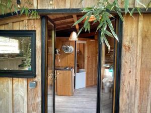 an outside view of a house with a sliding glass door at Cabane du Bertic in Lège-Cap-Ferret