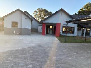 an empty parking lot in front of a building at Tranquility at Homely Escape in Phalaborwa