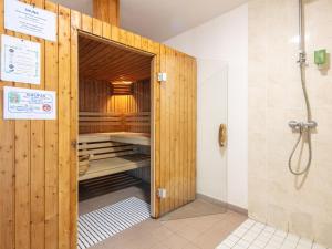 a bathroom with a sauna with a wooden door at Le Birdie NI105 - ST2 in Giez +10 photos