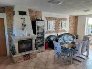 a dining room with a table and a fireplace at Rašovka - Bílý dům in Šimonovice