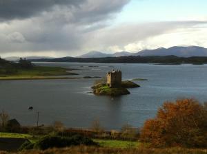 a castle on an island in a body of water at Cool Getaway in Appin in Portnacroish +24 photos