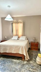 a bedroom with a large bed and a window at Casa Arena - 4 Pax, 5 min de la playa, con parking in Las Galeras