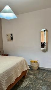 a bedroom with a bed and a mirror on the wall at Casa Arena - 4 Pax, 5 min de la playa, con parking in Las Galeras