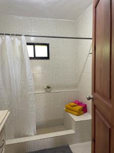 a bathroom with a shower with a yellow towel at Casa Arena - 4 Pax, 5 min de la playa, con parking in Las Galeras