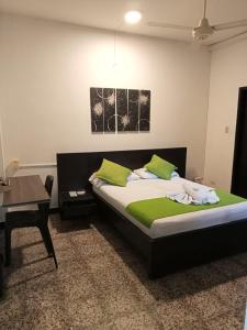 a bedroom with a bed with a desk and a table at Hotel Chicala salgar in Puerto Salgar +43 photos