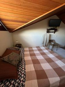 a bedroom with a bed and a flat screen tv at Flat Monte Castelo em Gravata PE in Gravatá +33 photos