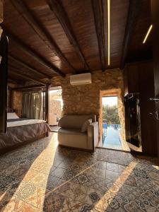 a bedroom with a bed and a couch in a room at Beit el loz in Ghazīr
