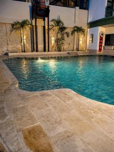 a swimming pool in the middle of a building at Hotel Chicala salgar in Puerto Salgar