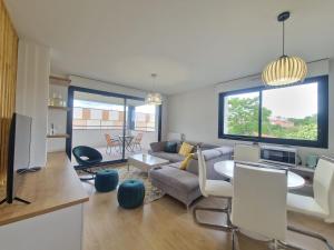 a living room with a couch and a table at Le Savannah #Parking#Terrasse in Clermont-Ferrand
