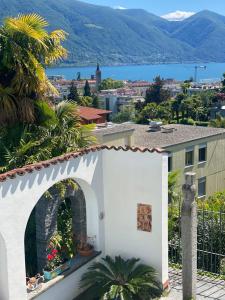 a white building with a fireplace with a view at Villa Incanto in Ascona