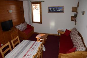 a small living room with a couch and a table at A27 Chalet du Galibier in Valloire