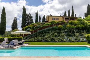 a villa with a swimming pool and a house at Villa Sabrina by PosarelliVillas in San Gimignano