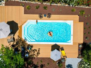 an overhead view of a swimming pool with people in it at Villa Polyxeni Lavender 150m from the sea in Politika