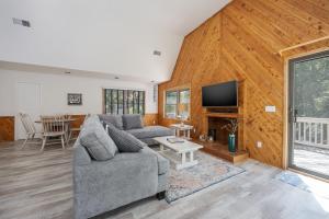 a living room with a couch and a tv at 2507 - Salty Sandpiper in Duck