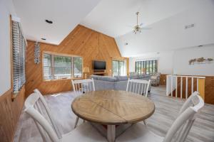 a living room with a table and chairs at 2507 - Salty Sandpiper in Duck