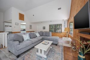 a living room with a couch and a table at 2507 - Salty Sandpiper in Duck