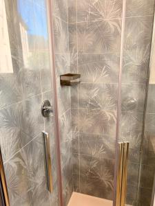 a shower stall with a glass door with palm leaves at Il Fico Lake Iseo b&b in Iseo +41 photos