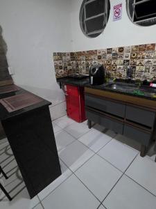 a kitchen with a sink and a counter top at Hospedaria Vitoria in Vitória +11 photos