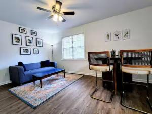 a living room with a blue couch and a ceiling fan at Bright & Spacious 1BR - UoM Area in Memphis