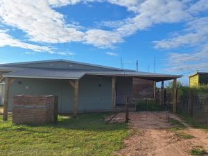 a house with a metal roof on top of it at Nyumba in Colonia Nuevo Paysandú