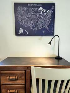 a desk with a lamp and a picture on the wall at Bright & Spacious 1BR - UoM Area in Memphis