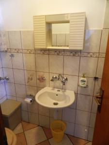 a bathroom with a sink and a mirror and a toilet at Apartment Jakoubek in Rogoznica +60 photos