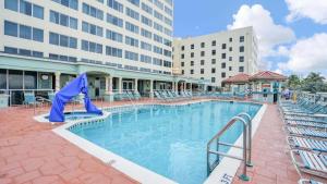 a pool at a hotel with chairs and a building at Hollywood Beach Tower - Studio Suite in Hollywood